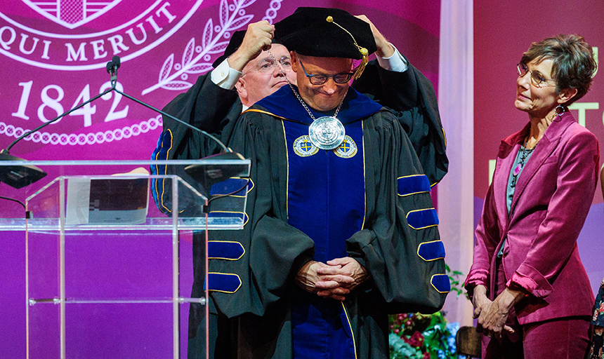 President Emeritus Michael Maxey bestows the presidential medal upon Roanoke College's 12th president, Frank Shushok Jr., as the Rev. Kelly Shushok looks on.