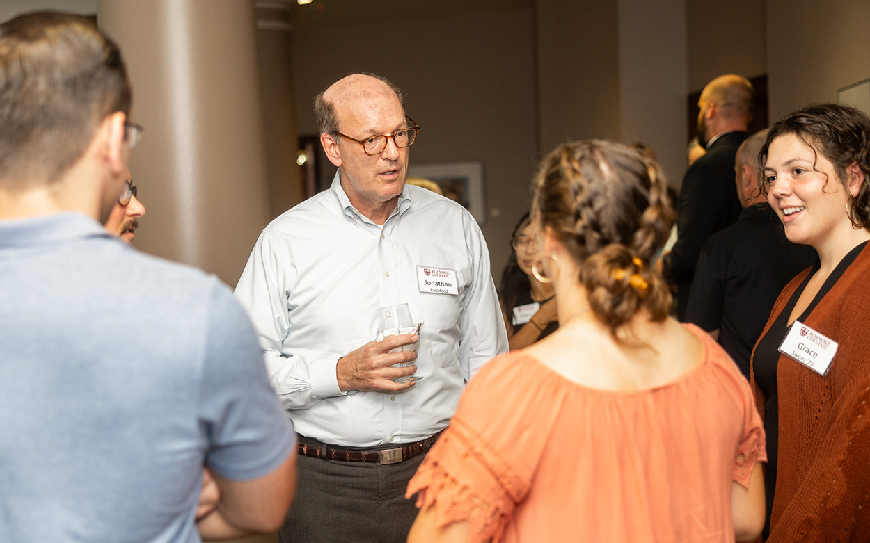 Jonathan Reckford smiles and talks with students