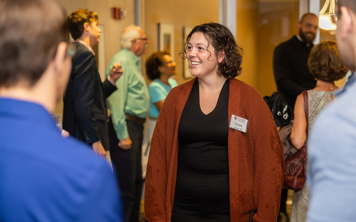 Roanoke College student and Habitat volunteer Grace Sweat smiles at an event with Jonathan Reckford