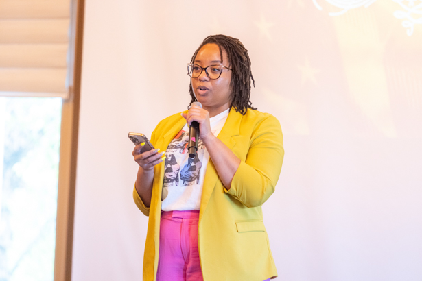 Alyasá Jones holds a microphone while addressing the crowd gathered for the celebration held in the Wortmann Ballroom