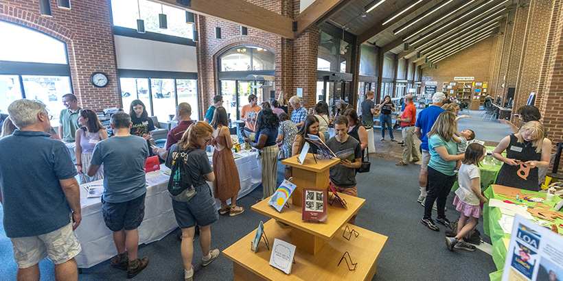 People pour into the foyer of the Salem Public Library to see the unveiling of the books produced by the Science Storytelling class