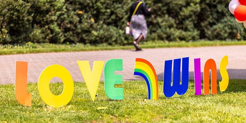 A sign on the quad spells out the words LOVE WINS