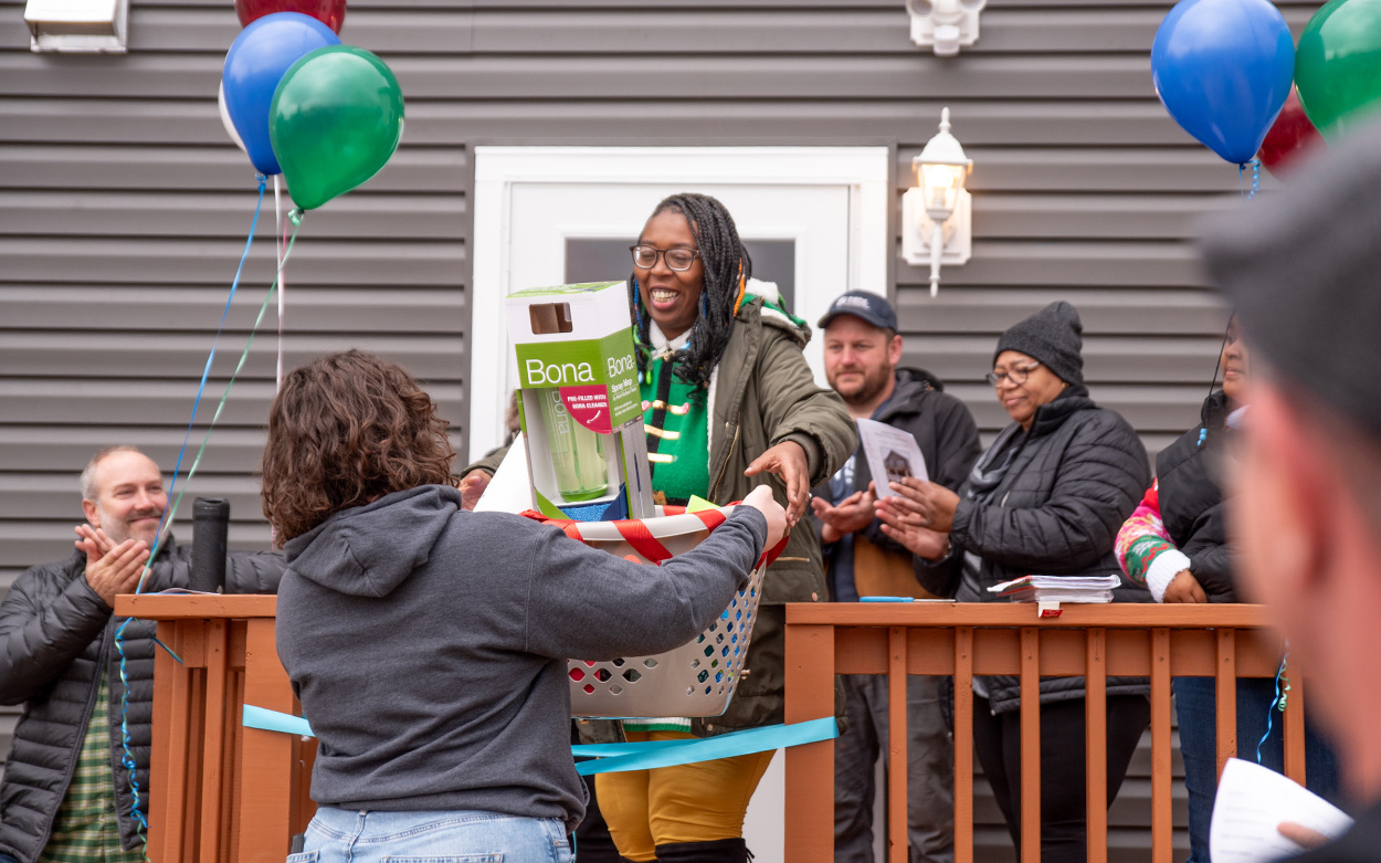 Keshia Jones smiles while being presented with a basketful of gifts.