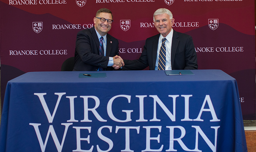 President Shushok of Roanoke and President Sandel of Va Western shake hands. 