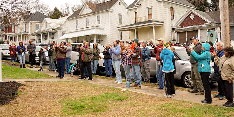 Habitat volunteers gather for the dedication of R House 2022