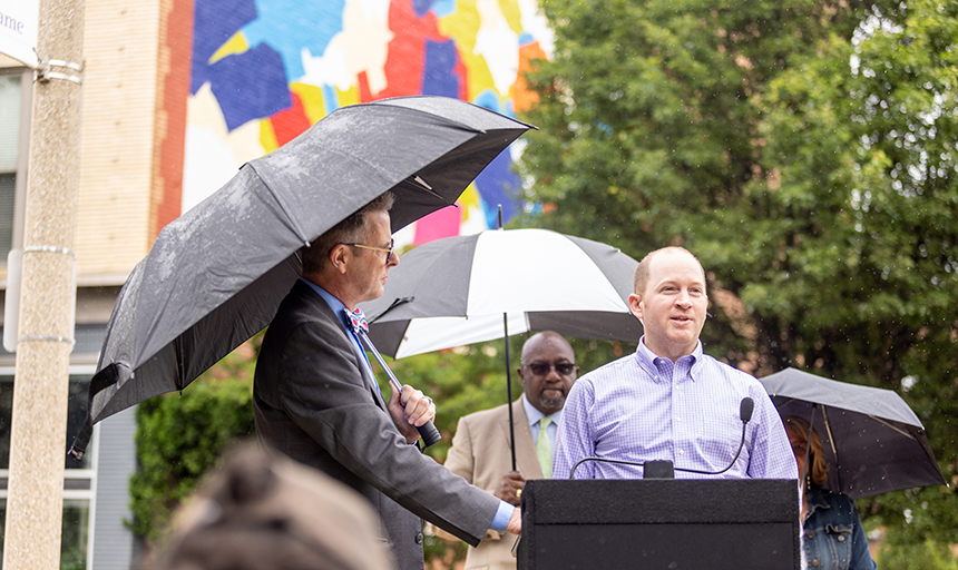 Reyn Holden '12 addresses the crowd at the dedication of the restored Dorothy Gillespie mural in Roanoke.