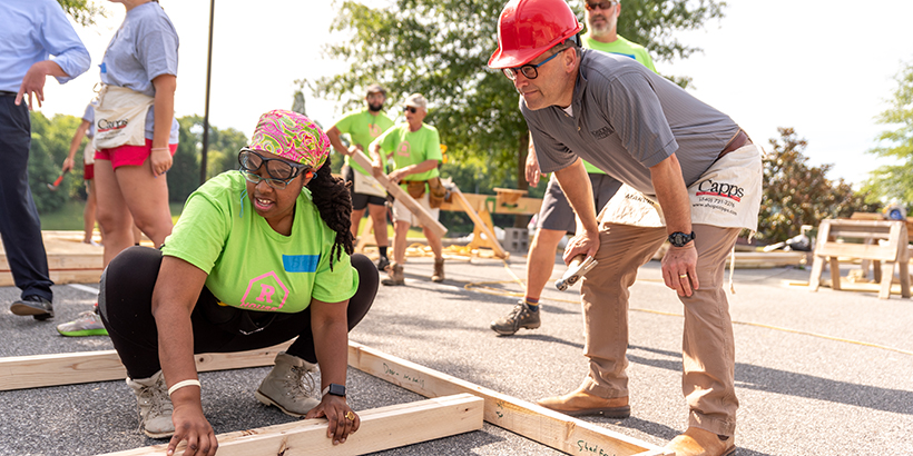 Homeowner Sirena Perry talks construction topics with FrankShushok. 