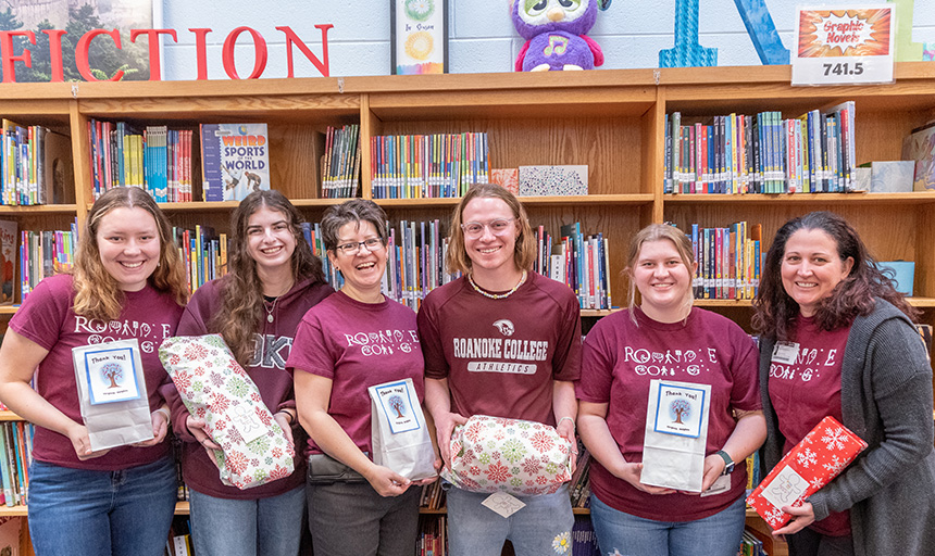 McCutcheon and student volunteers smile during a Toy Like Me delivery at a local school