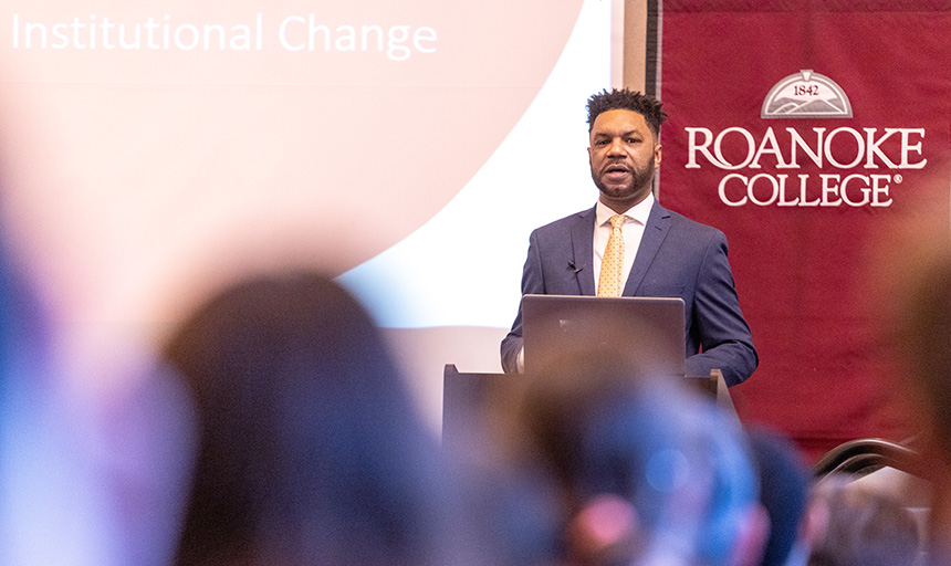 University of Richmond's Ernest McGowen III speaks from the dais of the Wortmann Ballroom against a backdrop of a Roanoke College banner
