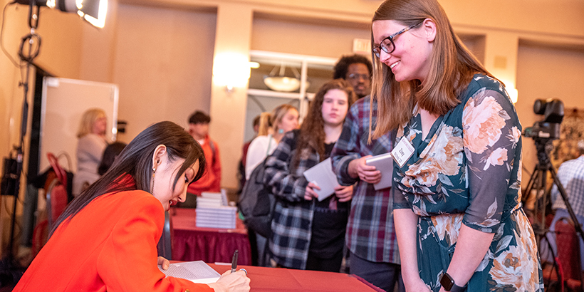 Yeonmi Park signs a book for Zoey Nichols