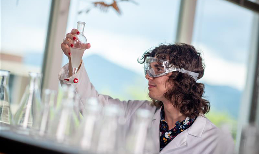 Student looking at a beaker