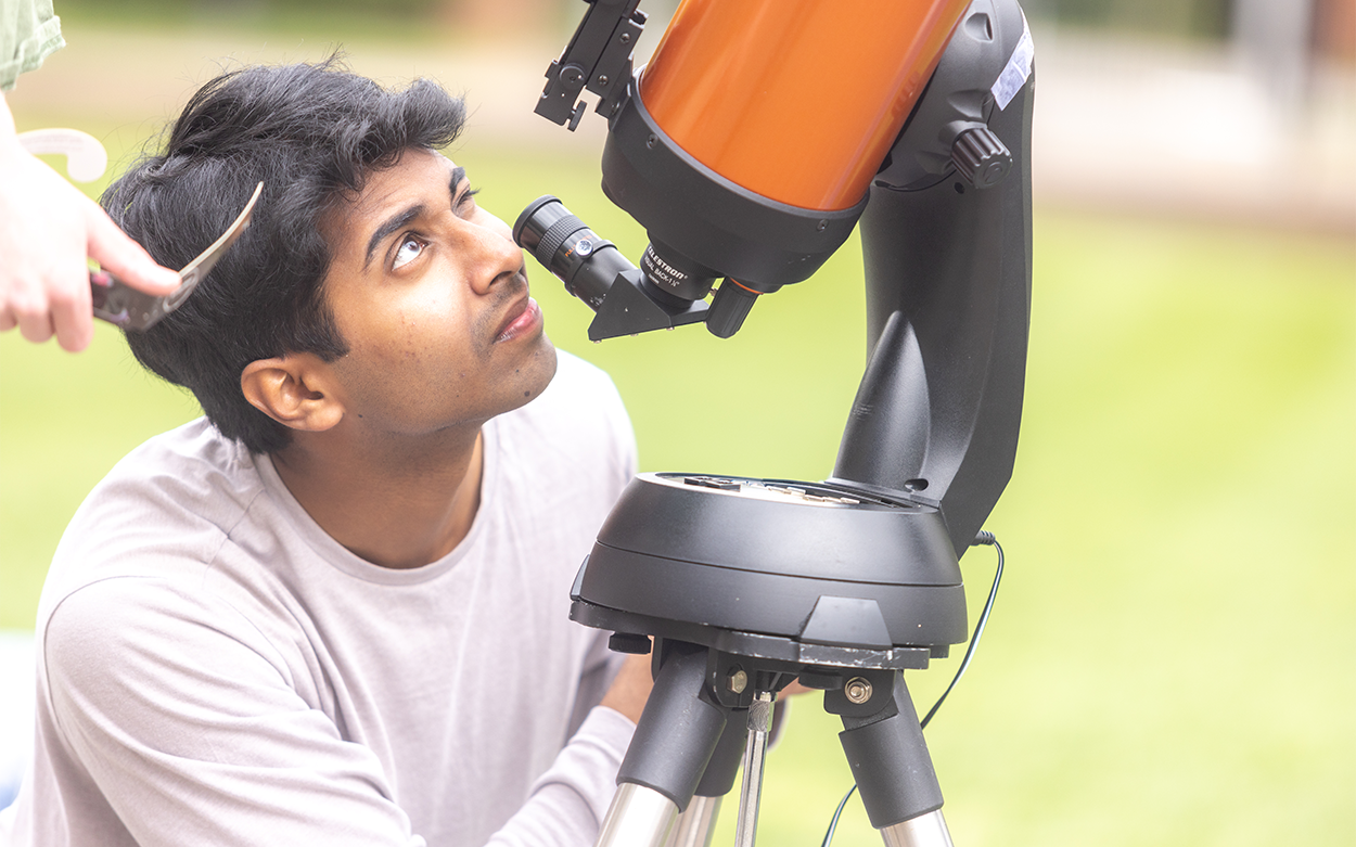 A student checks out the view through the telescope