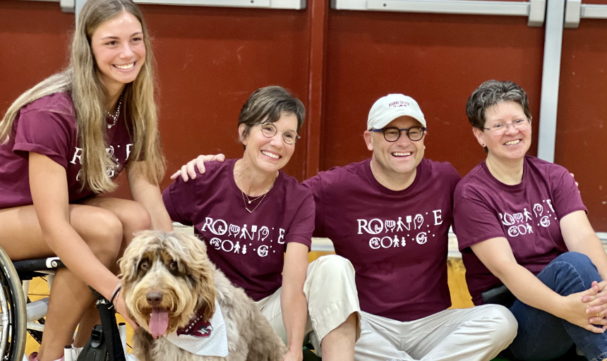 Photo of Maple the dog and four people wearing MAPLE'S Kids shirts