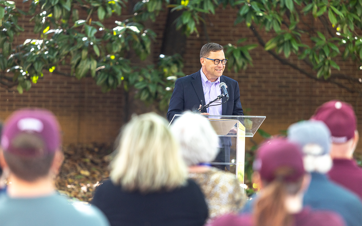 Roanoke College President Shushok addresses a crowd from a podium