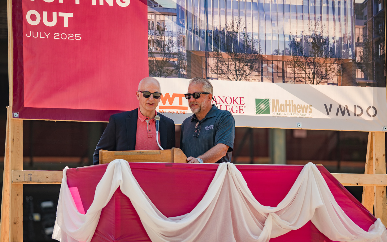 Two people speak from a podium