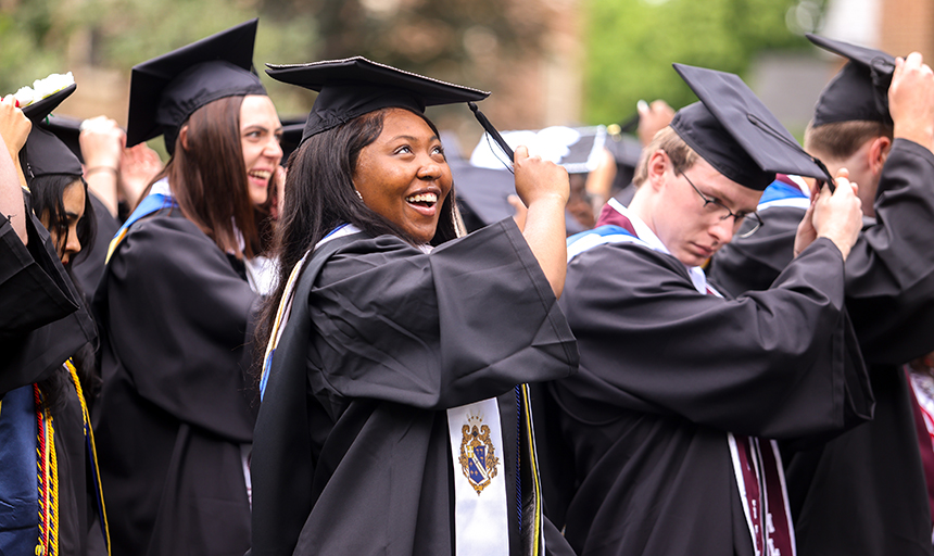 A student beams as she switches the tassel on her black graduation mortarboard to the opposite side, symbolizing the finale to her educational career at Roanoke.