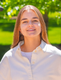 Young woman with long brown hair in a white button-down shirt