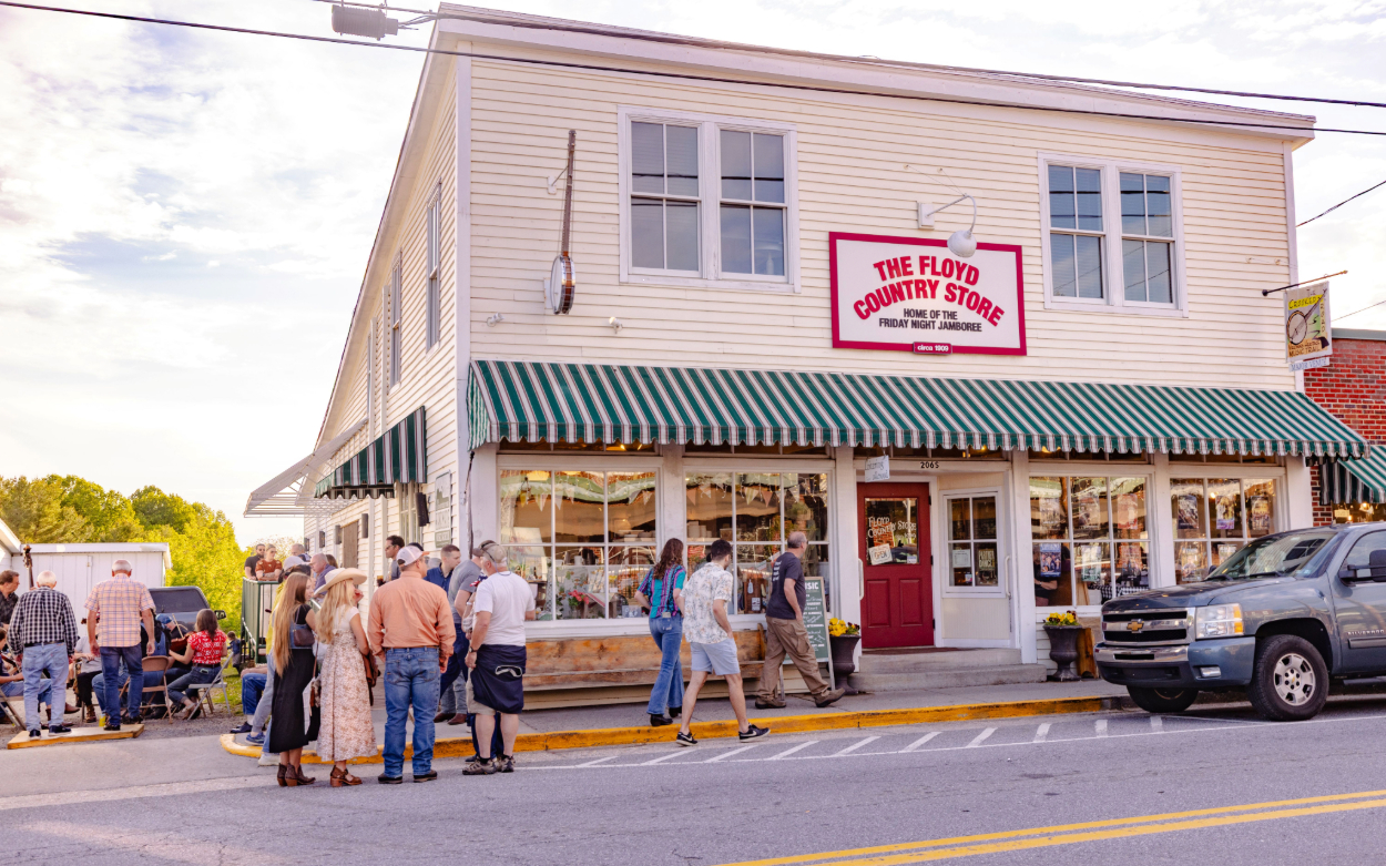 People stand in groups outside the Floyd Country Store in Floyd, Va. 