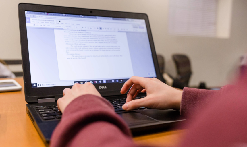 A student typing on a laptop