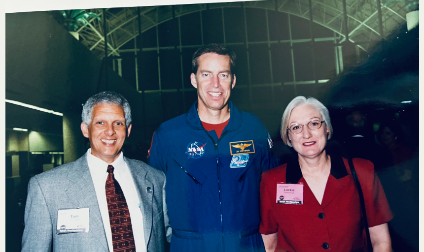 Three people smile for a photo