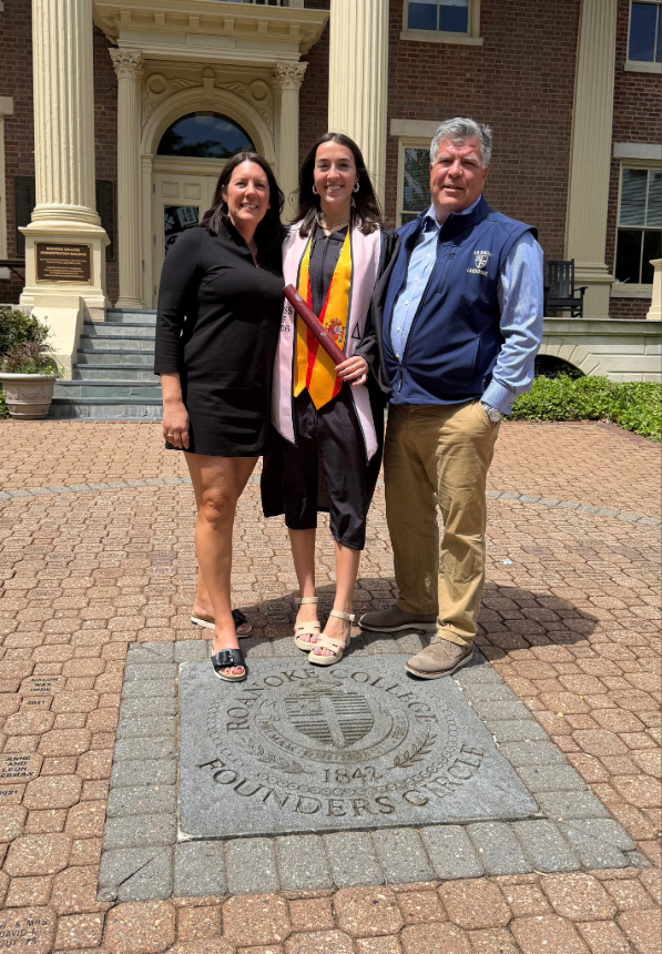 A couple stands with their daughter on the Roanoke College seal