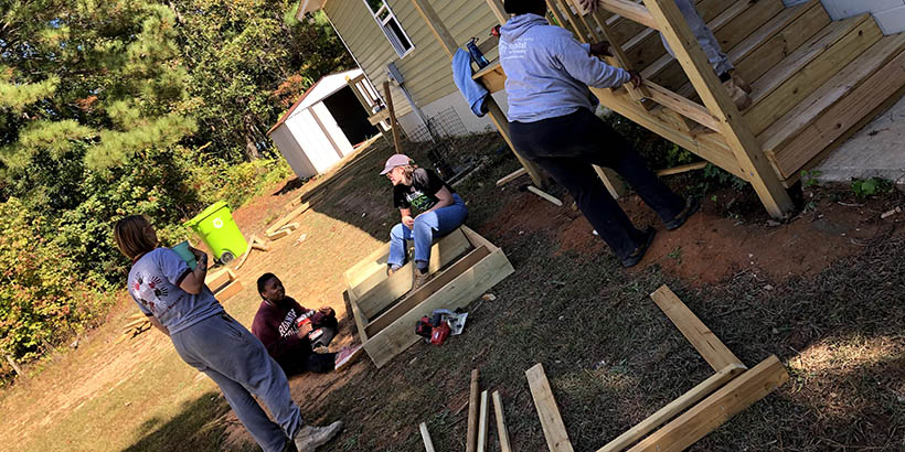 students working on a house