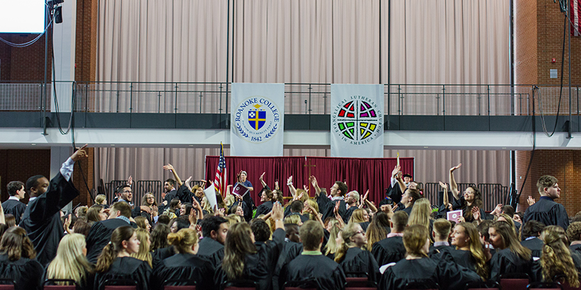 Students waving their hands in the air at Baccalaureate