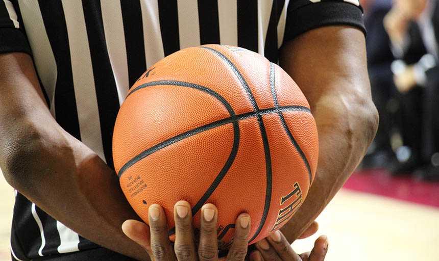 A referee holding a basketball