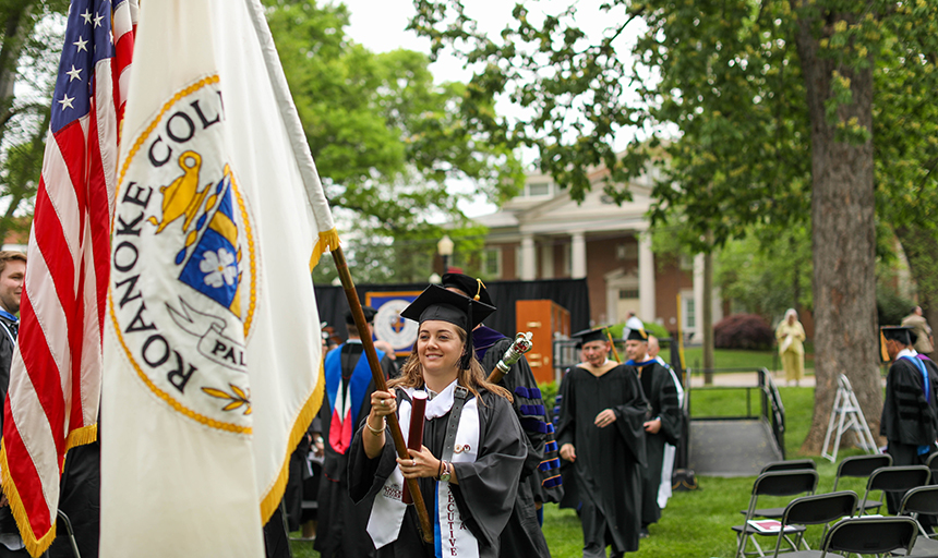 Graduates carry the flags as procession begins