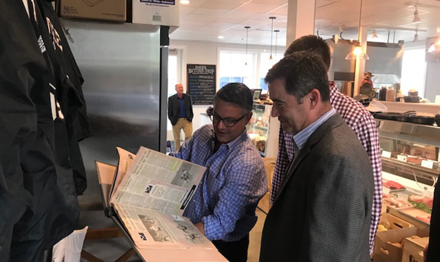 Mark DiBenedetto ’93 shows off his Roanoke College lacrosse scrapbook and memorabilia to Coach Bill Pilat ’85 and son Will Pilat ‘16