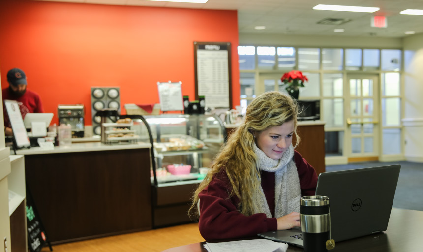 Student working in Fintel Library Cafe.