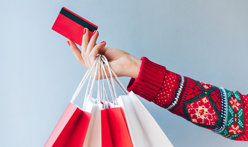 hand holding credit card and shopping bags