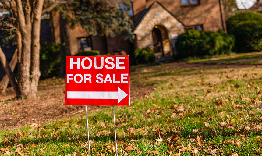 House for Sale sign in front of house