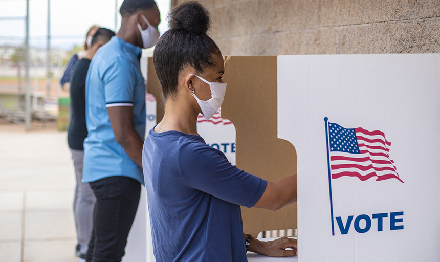 voters with masks at voting booth