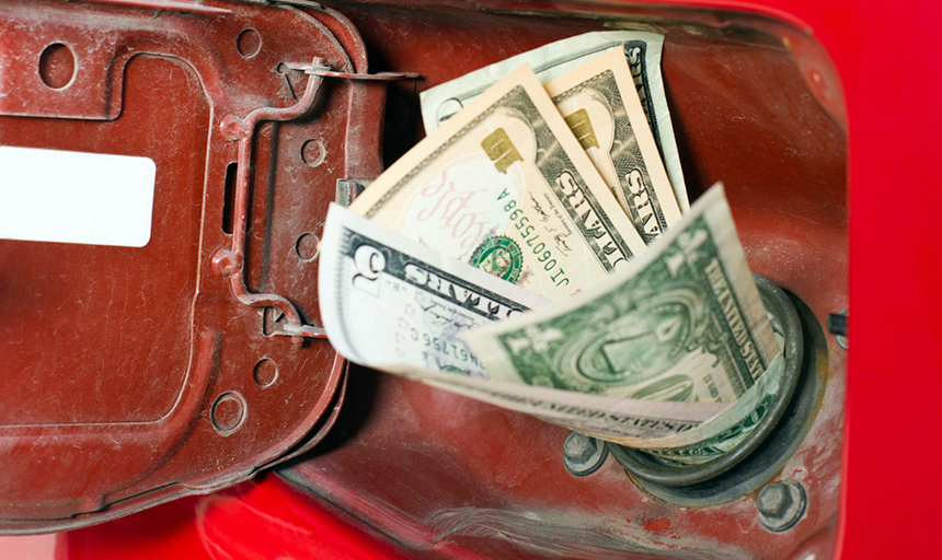 cash pictured going into gas tank of a car