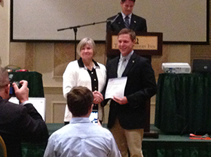 jacob brabham being presented with an award