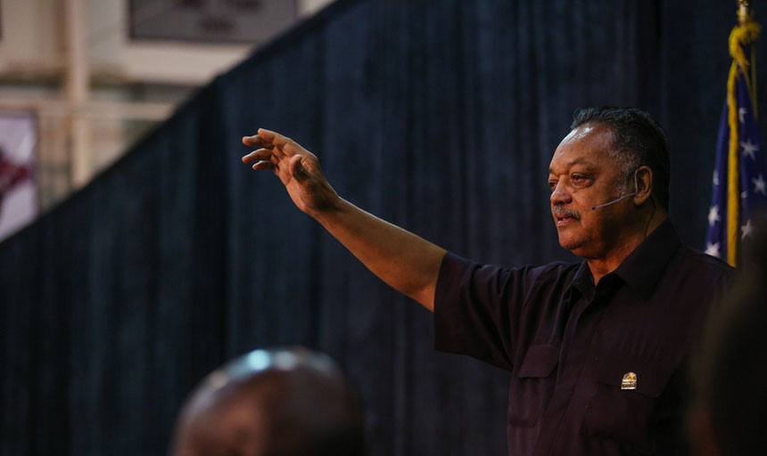 Jesse Jackson waves to the audience