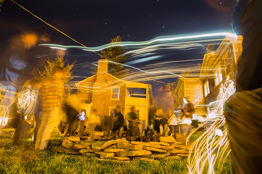 Students and staff at a bonfire with Joseph McGill