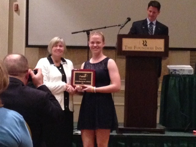 mary kelly being presented with an award