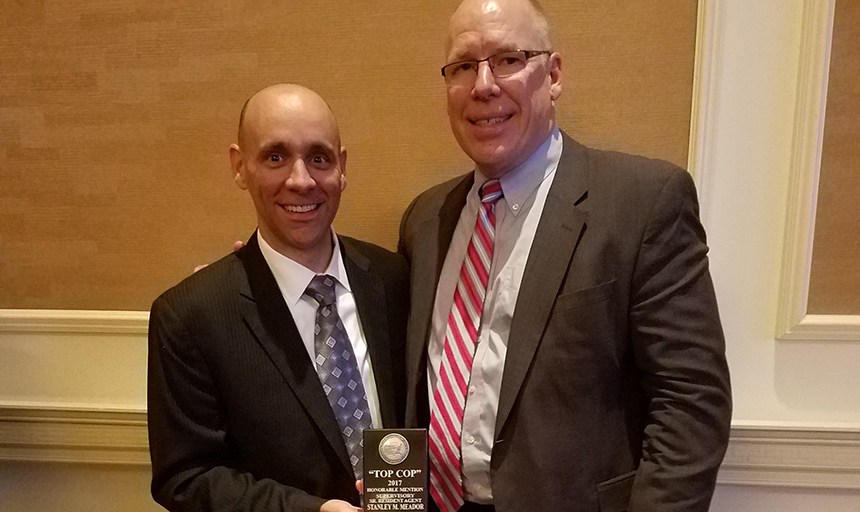 Stanley Meador, left, receives the Top Cop award from John Strong, Special Agent-In-Charge of the FBI Charlotte Division. 