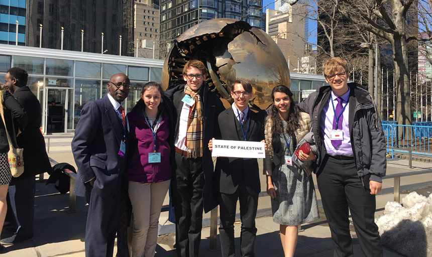 Model United Nations students pose with their sign for the state of palestine