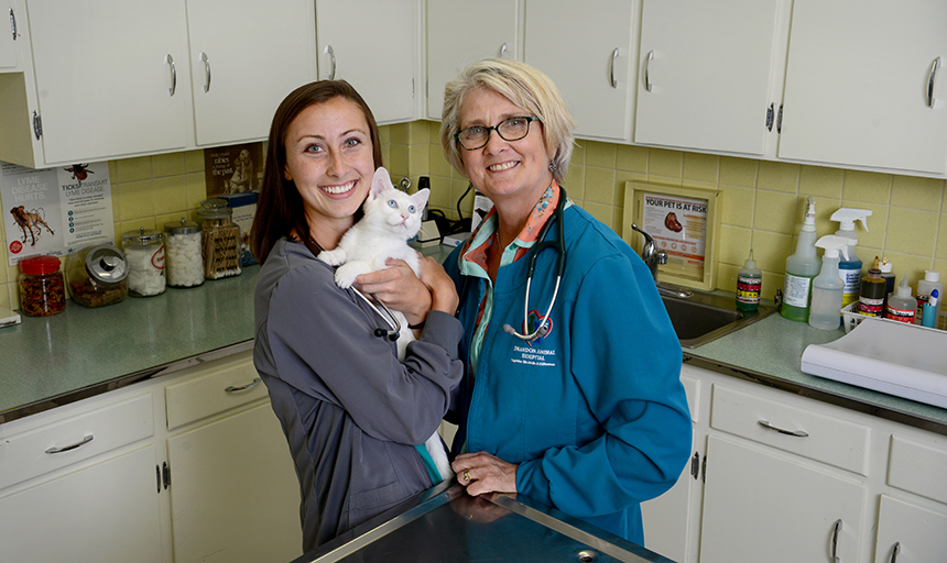 Sara Farthing holding a kitten with her mother