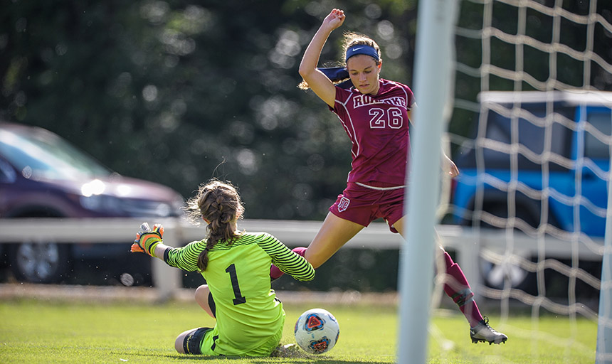 Guarino on the soccer field scoring a goal