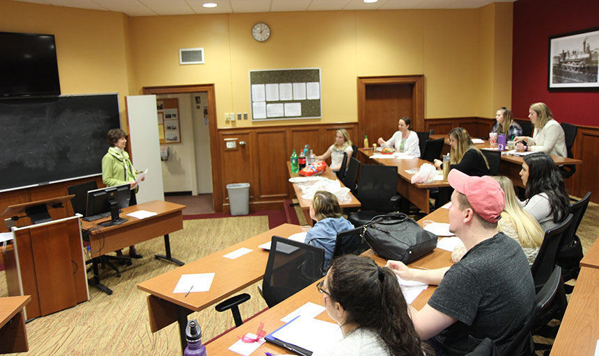 Students in a classroom listening to a speaker.