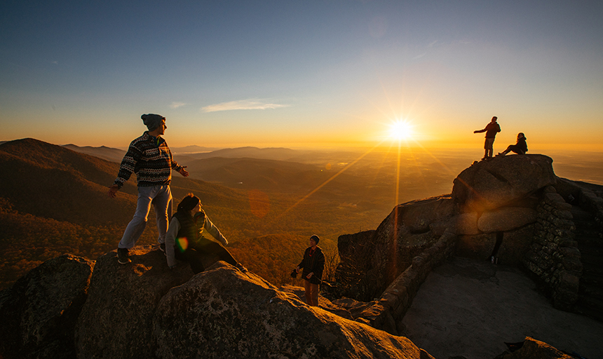Several students on top of Sharp Top at sunset