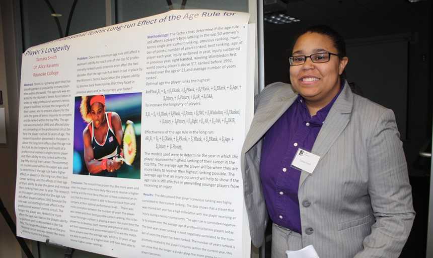 Tamara Smith with a poster of research she completed