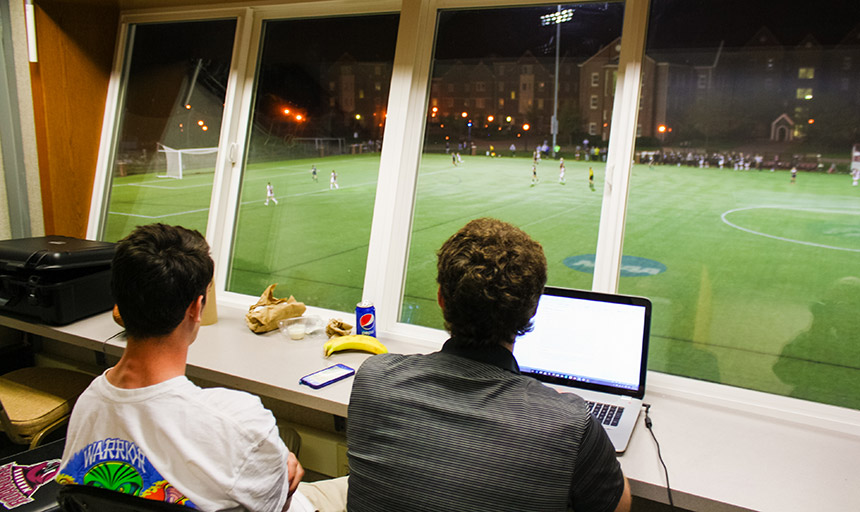 students watching a game and running statistics