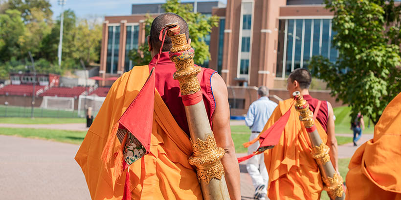 The Tibetan Monks walking across campus after the closing ceremony