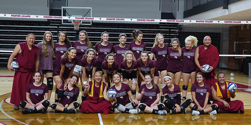 The Tibetan Monks join the women's volleyball team for a photo