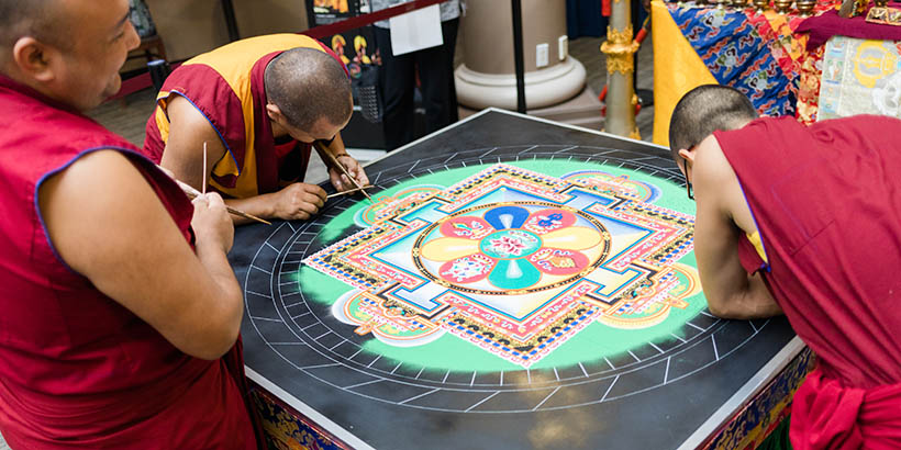 The Tibetan Monks working on the sand mandala, it is about halfway done
